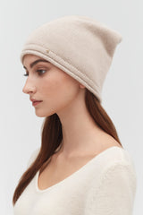 Woman wearing a beanie, profile view.