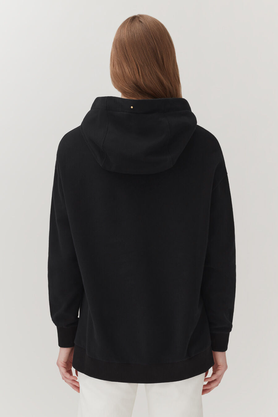 Person wearing a hooded top, seen from the back.