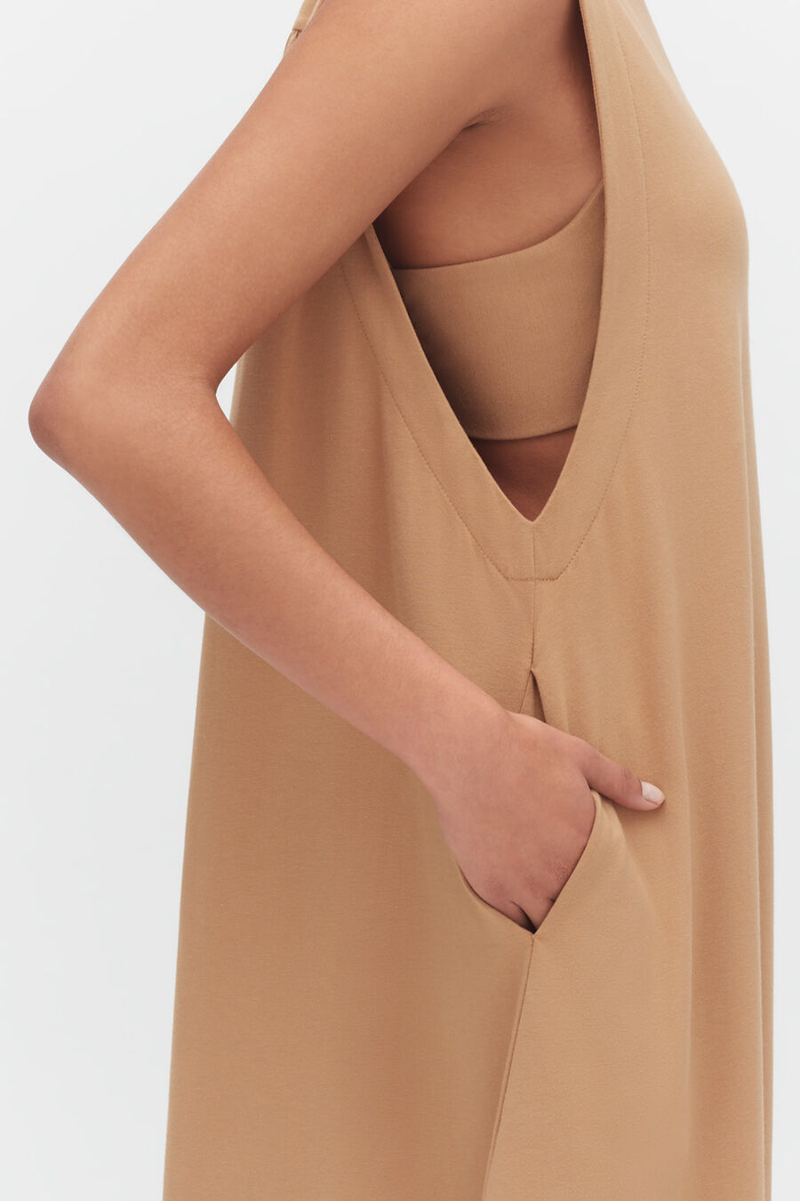 Person pointing to their dress pocket