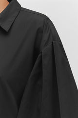 Close-up of a shirt's collar and sleeve.