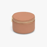 Round jewelry box with a zipper closure on a plain background.