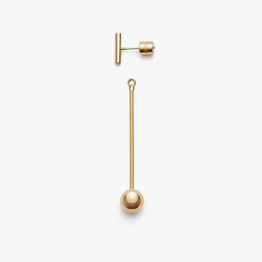 A set of metal jewelry pieces including a bar, a stud, and a long pin with a ball.