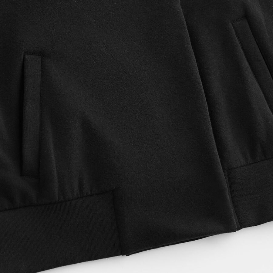 Close-up of a pleated skirt with visible stitching and folds.