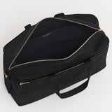 Travel bag with zippers and a shoulder strap.