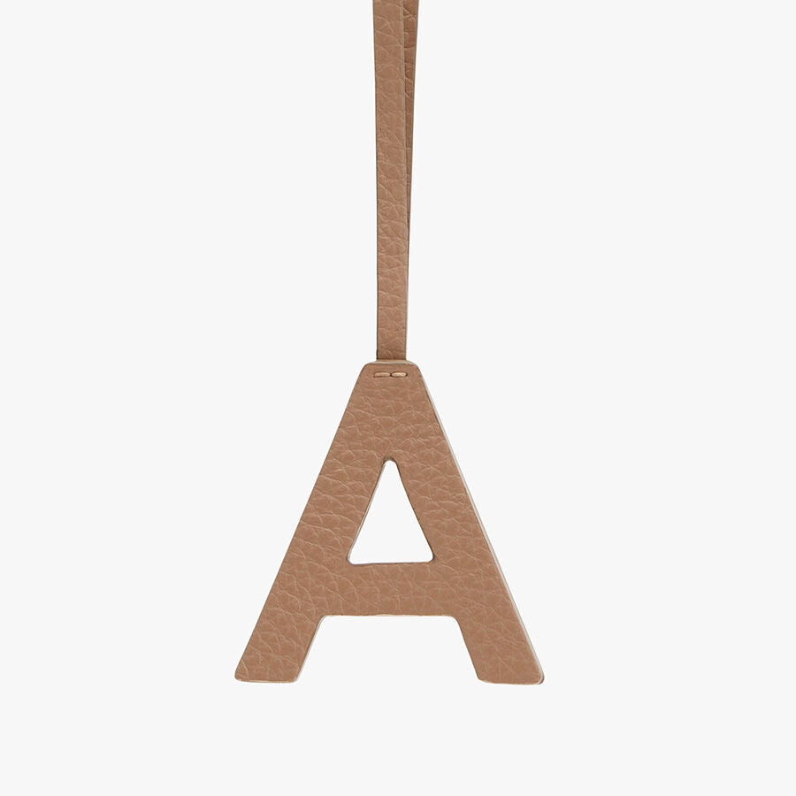 Letter A pendant hanging by a strap.