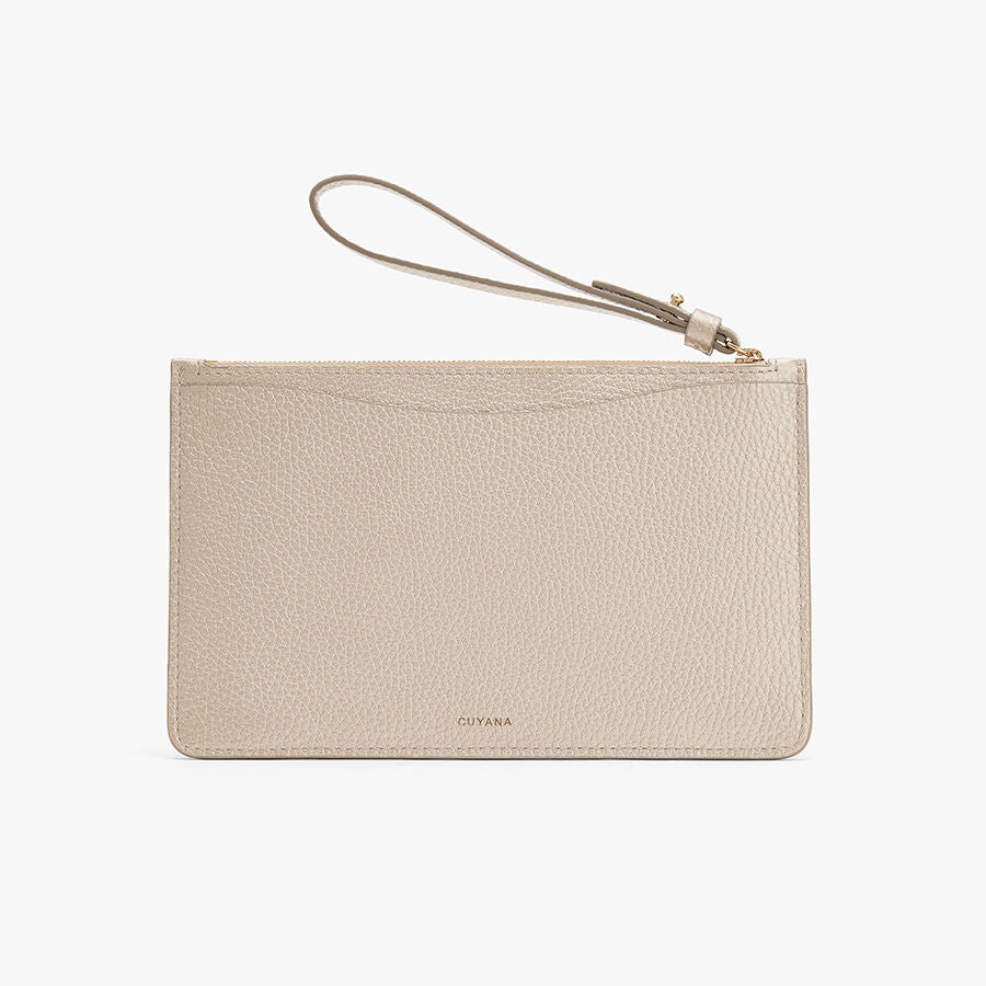 Wristlet clutch with a zipper and attached strap.