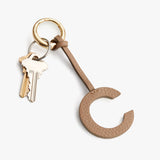 Key ring with keys and a letter C-shaped charm attached.