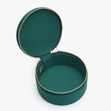 Open round jewelry box with zipper on white background.