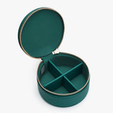 An open round jewelry box with compartments and a zipper closure.