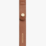 Strap with snap fastener and embossed text.