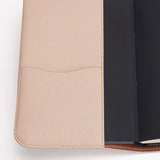 Notebook in a textured cover with a flap pocket.