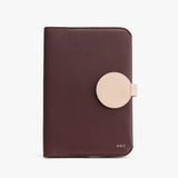 Wallet with circular clasp and monogram initials