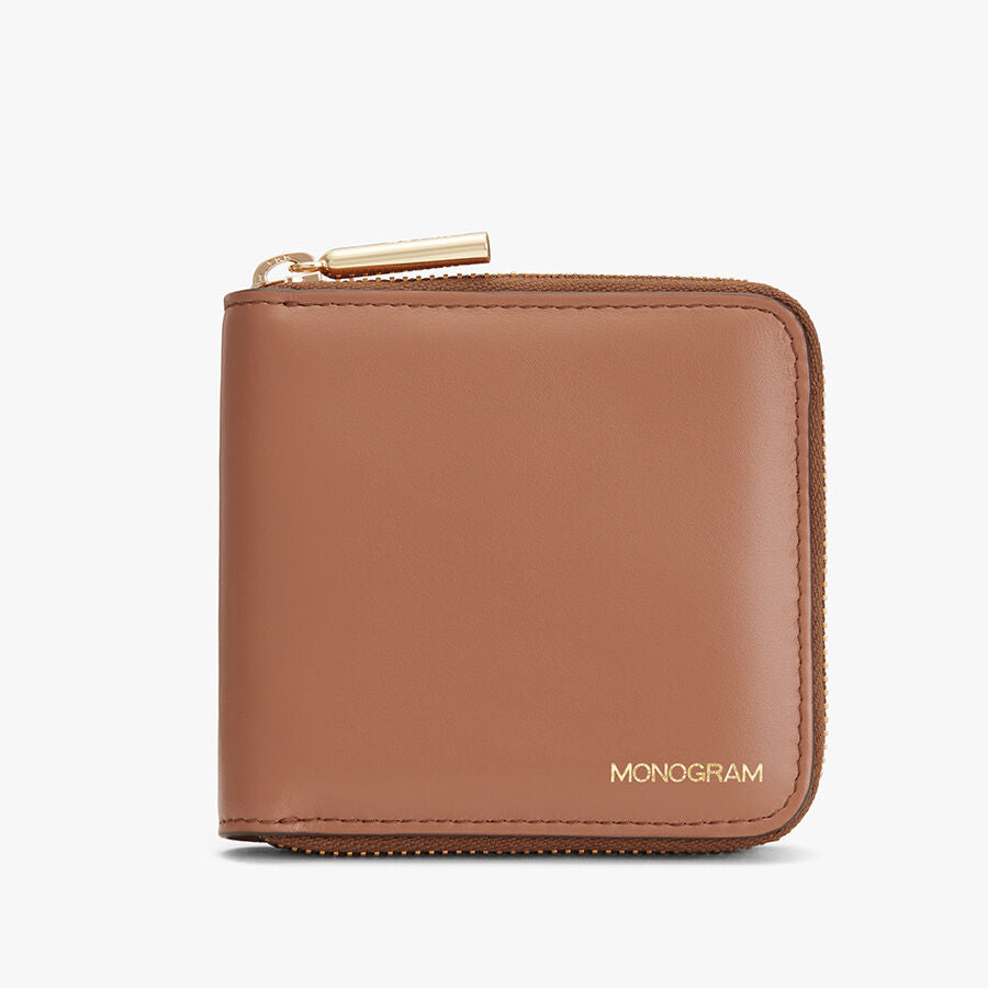 Zippered wallet with monogram on front.