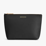 A small zipper pouch with the word MONOGRAM printed on one side.