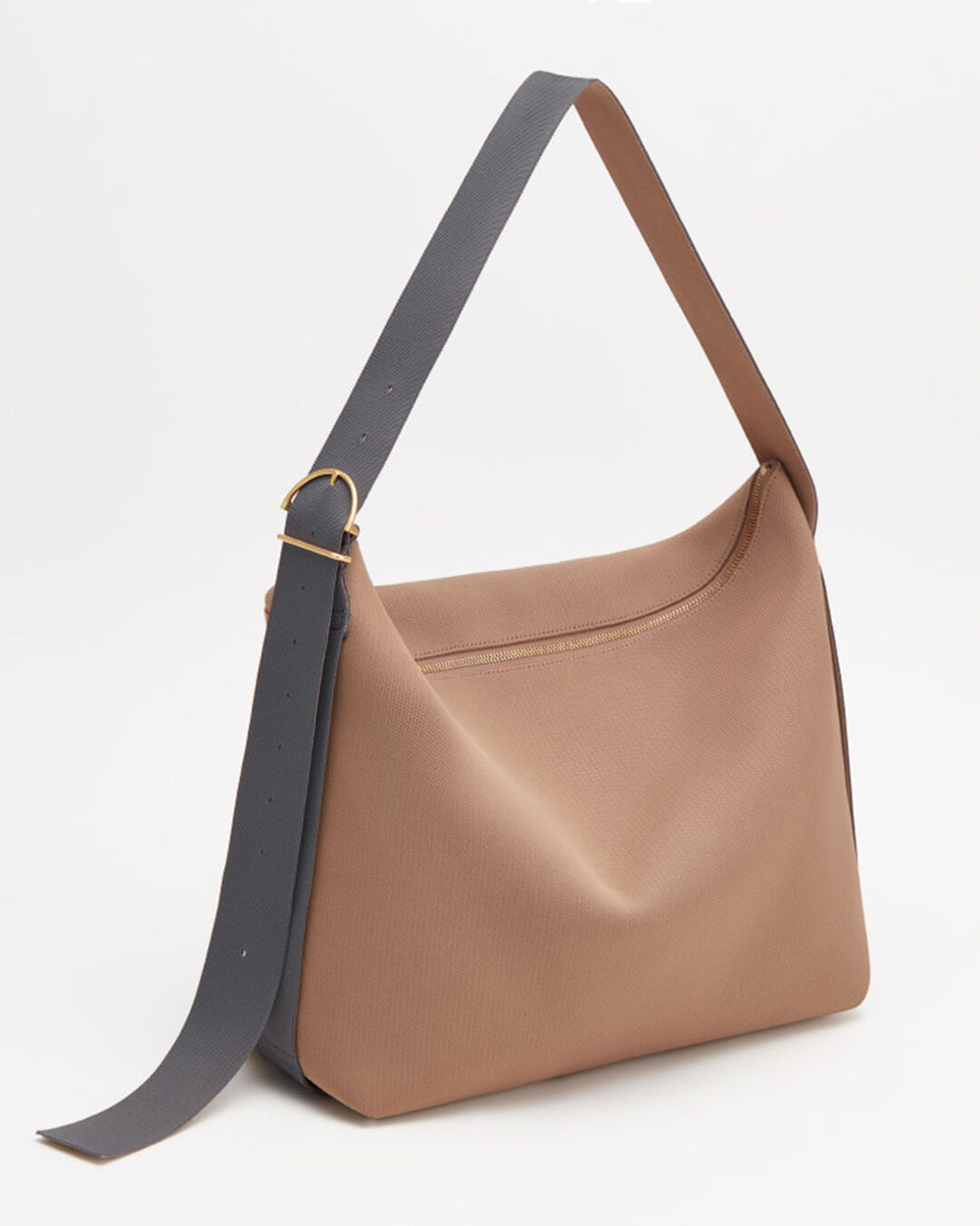 Handbag with a shoulder strap standing upright