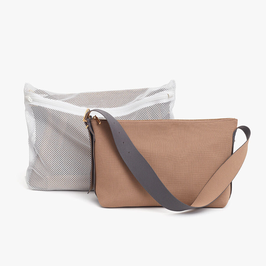 Two different styled handbags with shoulder straps.
