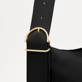 Close-up of a strap with a buckle and adjustable holes.