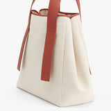 Tote bag with long handles standing upright