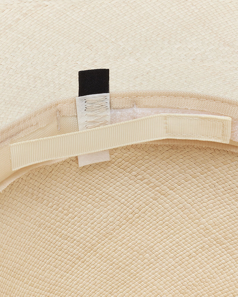 Close-up of a hat's inner ribbon and label.