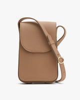 Textured crossbody bag with flap closure and adjustable strap