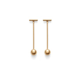 Two bar and ball drop earrings on a plain background.
