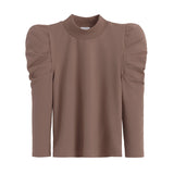 Blouse with round neckline and puffy sleeves.