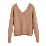 Sweater with long sleeves and a V-neckline on a plain background.