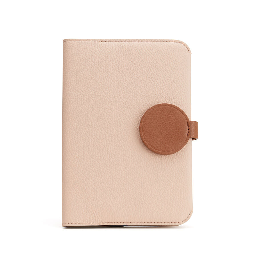 Closed wallet with circular flap closure on plain background.
