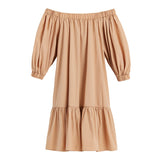 Off-shoulder dress with long sleeves and ruffled hem.
