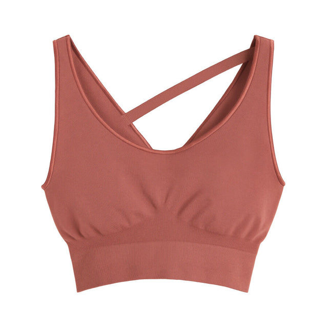 Sports bra with crisscross straps on a plain background