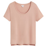 T-shirt with short sleeves and scoop neckline on plain background.