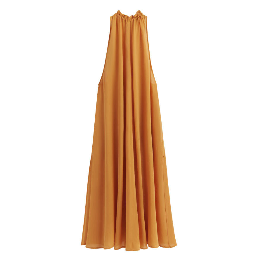 A long, sleeveless, flowing dress on a plain background.