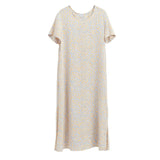 Short-sleeved dress hanging against a plain background.