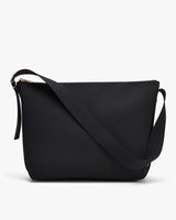 Black shoulder bag with adjustable strap and zip closure.
