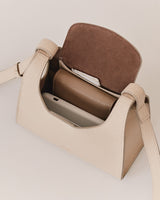Open handbag with a smartphone and wallet inside.