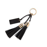 Keychain with two tassels and a tag attached to a metal ring.