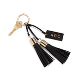 Key on a ring with two tassels and a tag labeled ABC.