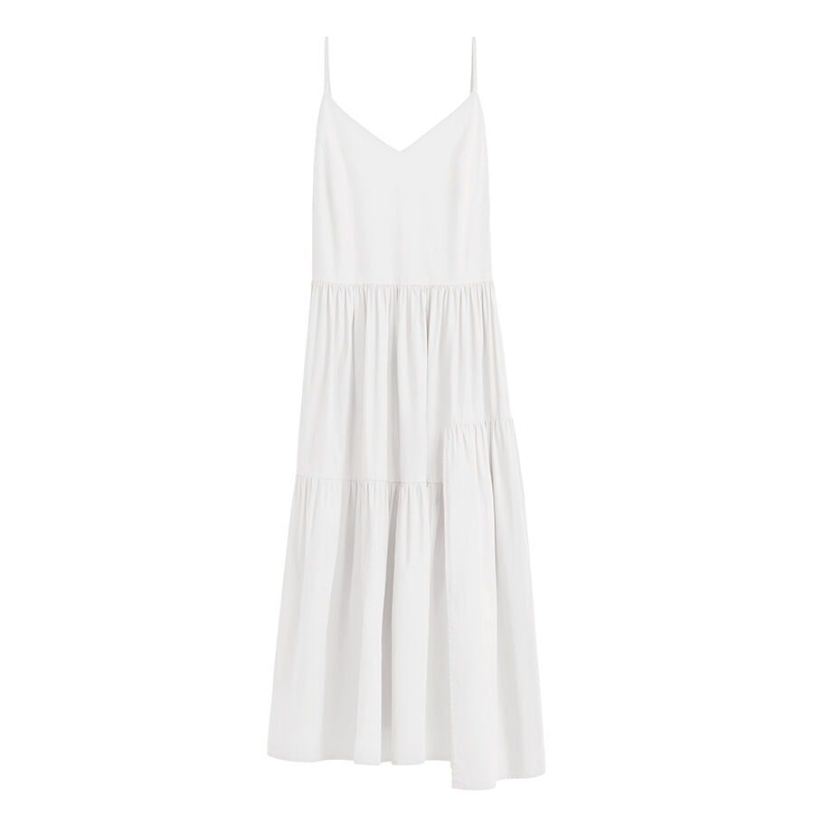 Sleeveless dress with tiered skirt on white background.