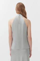 Woman facing away with hair down and an exposed back outfit with a zipper.