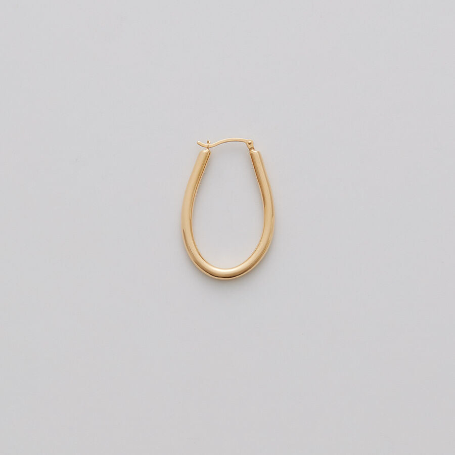 Single hoop earring on a plain background.