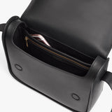 Open handbag with zipper pocket and an item inside.