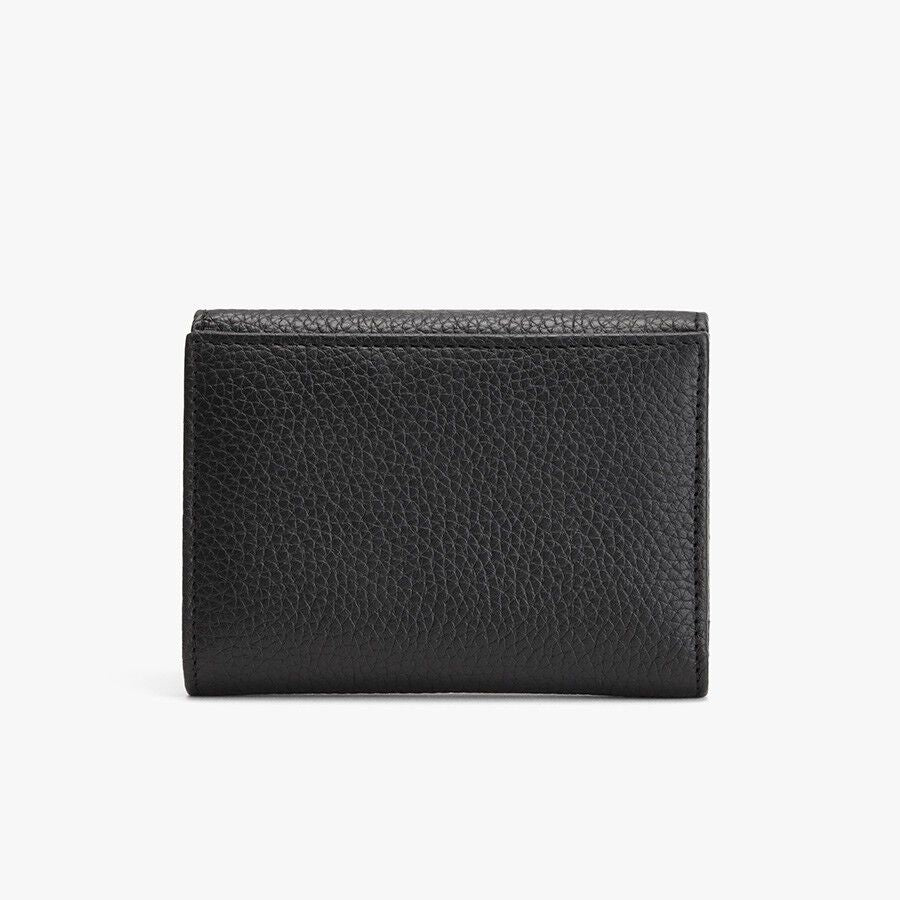 Closed black wallet on a light background