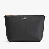 Small personalized pouch with zipper and initials ABC embossed on front.