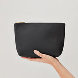 Hand holding a small zippered pouch
