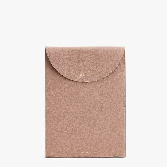 Envelope-style wallet with monogram initials on flap.
