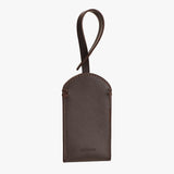 Leather luggage tag with loop handle and stitched edges.