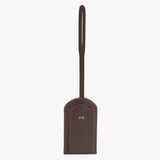 Leather luggage tag with loop handle and monogram initials.