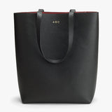 A tote bag with handles and the initials ABC.