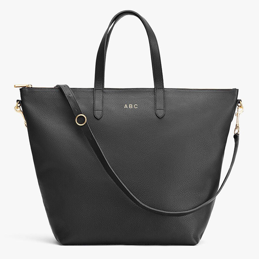 Handbag with top handles and a shoulder strap, labeled with initials ABC.