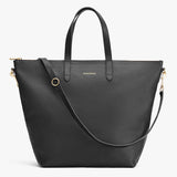 Leather tote bag with top handles and a shoulder strap.